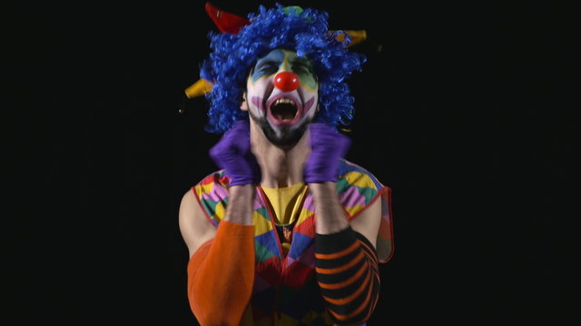 Young hilarious happy and funny clown being romantic making funny faces