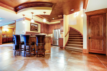 Excellent kitchen with a bar and large tile floor.