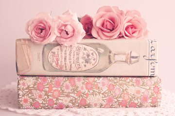 Roses over books with vintage dust jackets