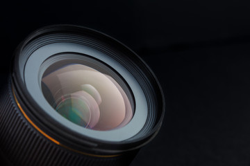 Camera photo lens with beautiful reflections isolated on black background