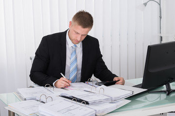 Businessman Examining Invoice