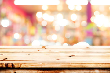 Empty wood table ready for your product display montage. Lights bokeh blurred background