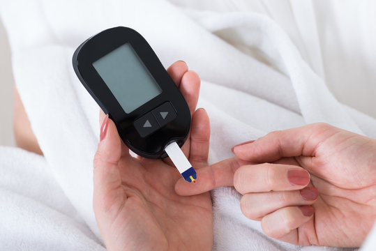 Woman Hand With Glucometer
