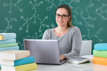 Woman Using Laptop In Classroom