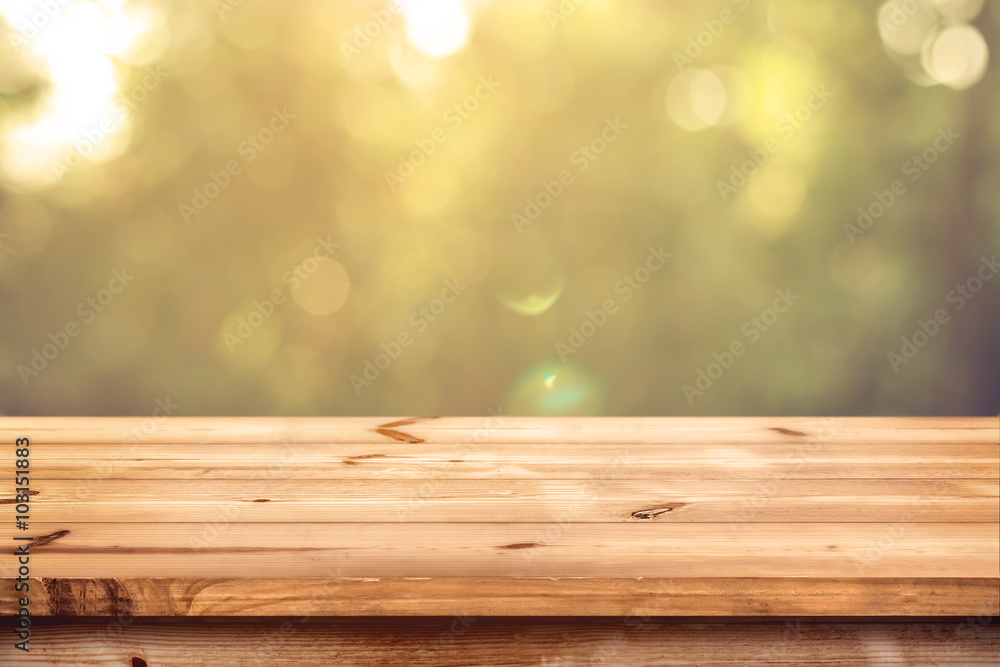Wall mural top of wood table with blurred bokeh nature background - empty ready for your product display montag