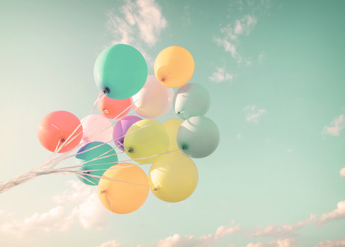 Multicolor balloons in summer holidays. Pastel color filter