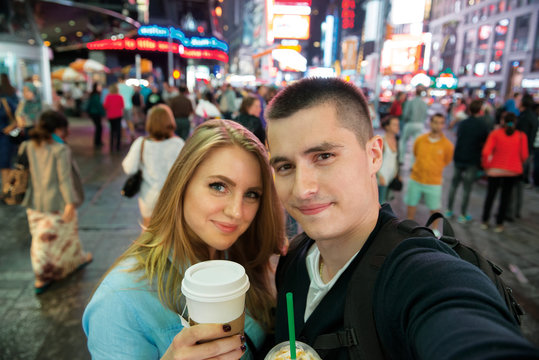Happy couple traveling in New York city and drinking coffee