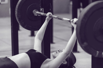 Sport girl doing exercise with barbell