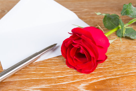 love letter envelope and red rose