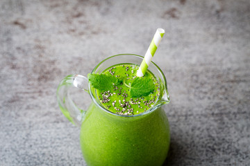 Spinach smoothie, on the grey  background.