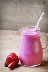 Smoothie, pink juice on the grey  background.