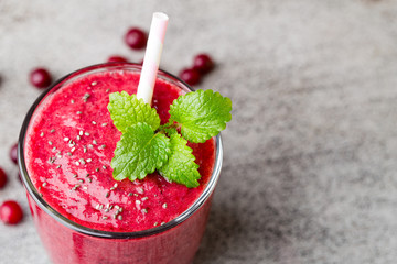 Smoothie, pink juice on the grey  background.