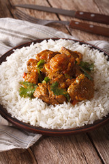Indian cuisine: beef madras with basmati rice close-up on a plate 
