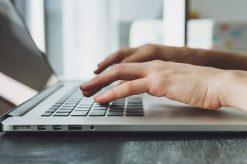 woman's hands working on laptop computer