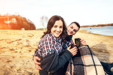 Young happy couple outdoor on the beach