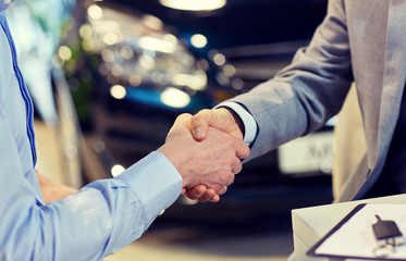close up of male handshake in auto show or salon