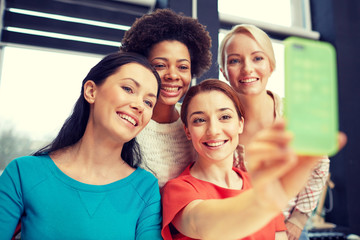 happy young women taking selfie with smartphone