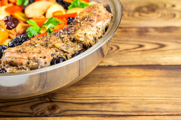 Healthy food, stewed pork meat with various colorful vegetables in pan on wooden background, selective focus
