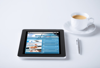 tablet pc with world news web page and coffee