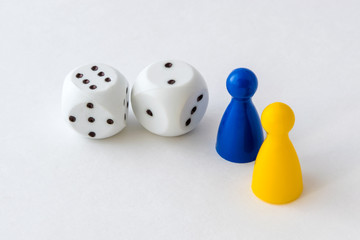 Board game pieces and dice on white background
