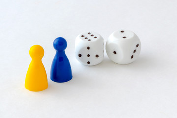 Board game pieces and dice on white background