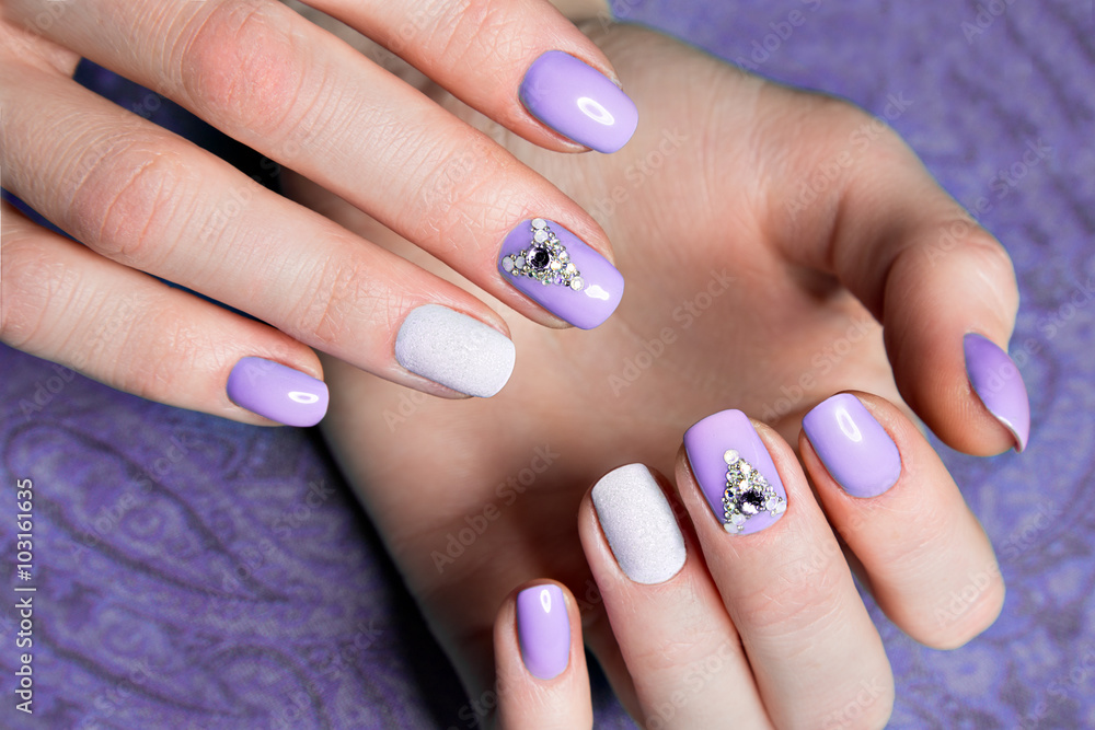 Canvas Prints beautiful purple manicure with crystals on female hand. close-up.