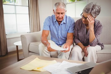 Senior man showing documents to woman