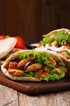 Pita salad with roasted chicken and vegetables, served with a de