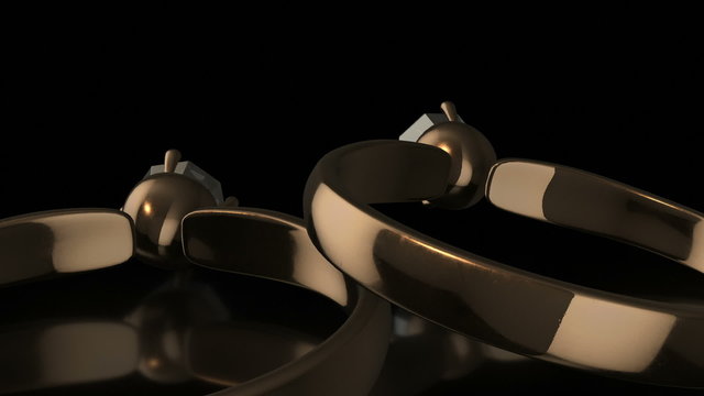 A pair of ultra realistic 3D golden rings with diamonds that explode at the end of the footage. Close-up camera movement against a black background.
