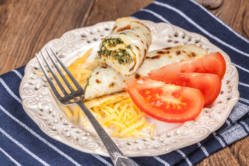 Crepes stuffed with cheese and spinach.