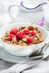 Bowl of cereals with raspberrie.