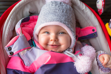 Portrait of baby girl in winter jacket and hat