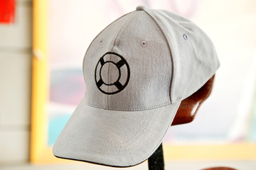 White cap with lifebuoy symbol on front