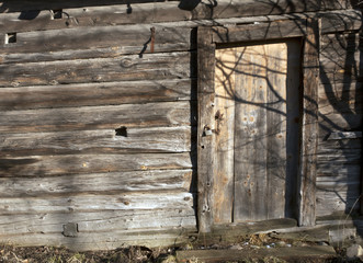 Old log house with closed door.
