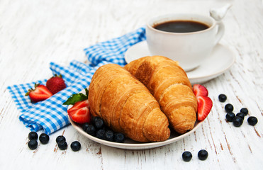 Fresh berries, coffee and croissant
