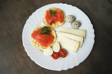 Breakfast: rice cracker with salmon, quail eggs, cheese, tomatoes.