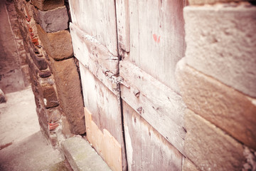 Solid old door blocked by a fence