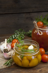 Canned marinated tomatoes in tomato juice on a wooden table