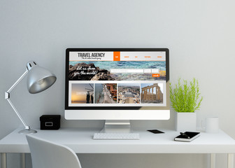 modern clean workspace with travel agency website on screen