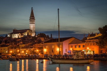 Sunset in old Crotian city Rovigno (Rovinj), in Istria, with old stone walking area next to the water.