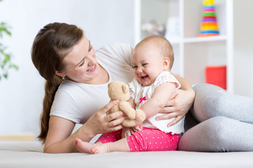 Mother plaing with her daughter baby