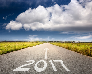 Empty road to upcoming 2017 against the big cloud