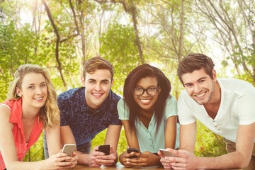 Composite image of creative team all using smartphones