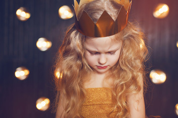 Beautiful little girl princess in a gold crown