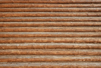 Texture of wall made of old wooden logs