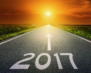 Empty road to upcoming 2017 at sunset