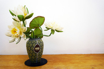 White flowers in vase on wooden table