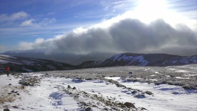 Looking down at Creag Ghleannain while returning from the summit of Geal Charn Mor near the Cairngorms in the Scottish Highlands in winter.