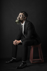 Virus Pandemic. Man dressed with a suit wtih a mask gas