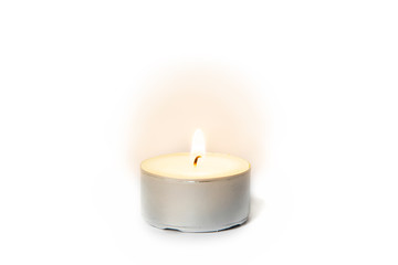 Fototapeta na wymiar Shining flame on a tea light candle